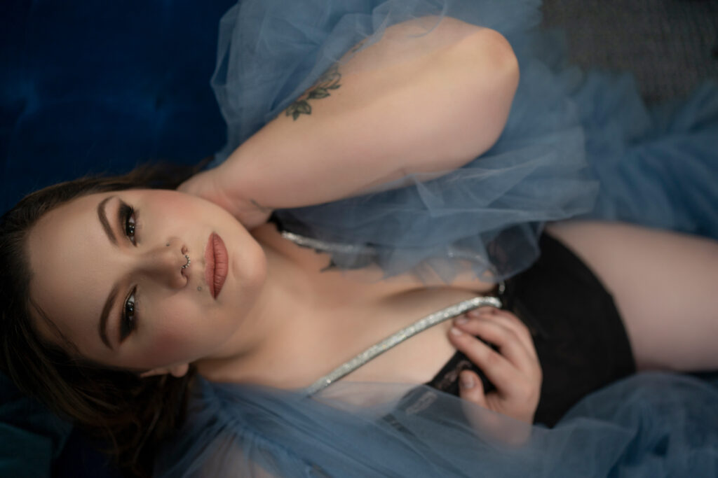 Beautiful curvy woman poses for her boudoir photographer session