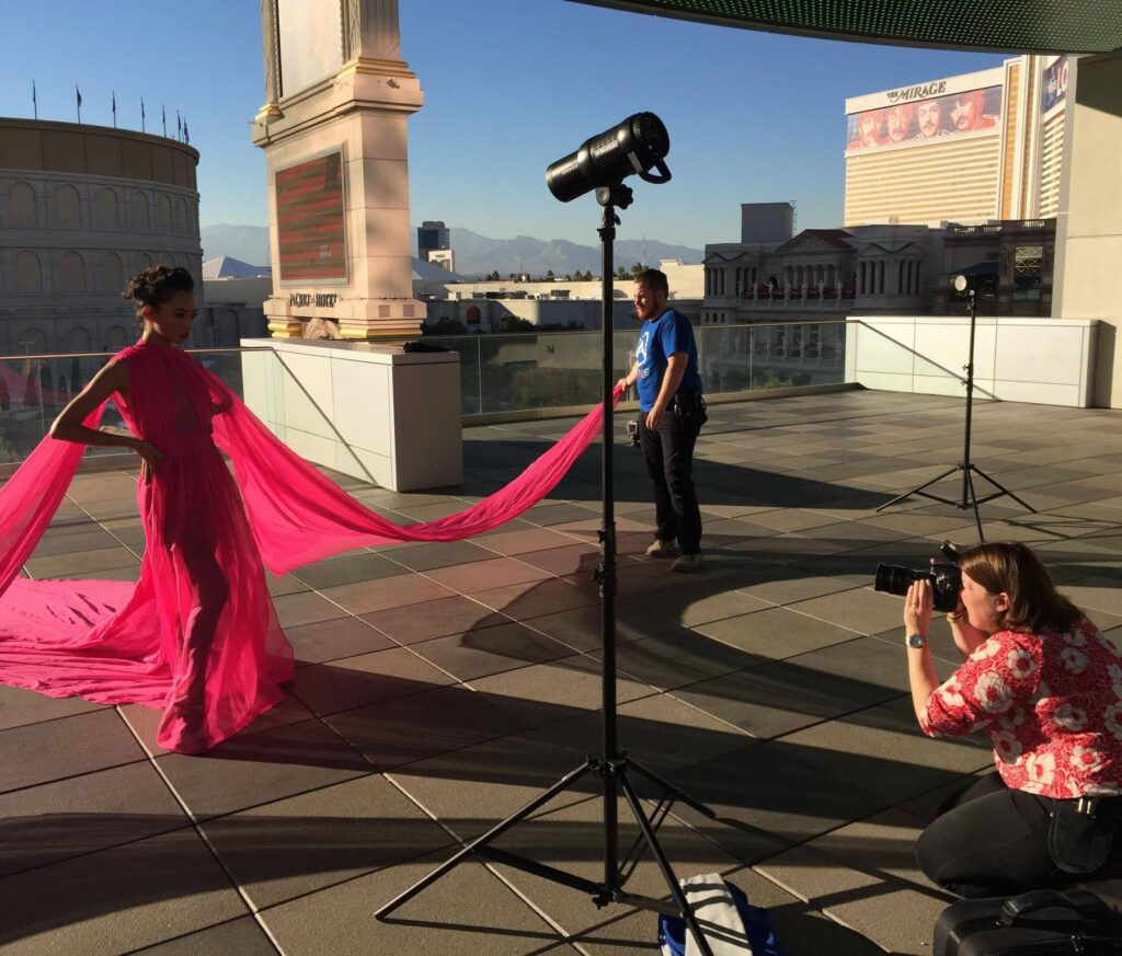 Boudoir photographer, Meg Wallace, photographing woman in flowing dress on rooftop in Vegas